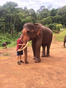 Grant hugging an elephant at Patara elephant farm