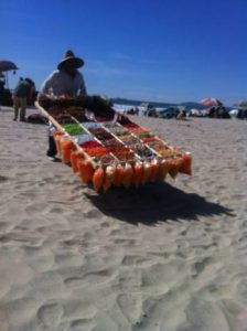 A man selling candy at Rosarito Beach