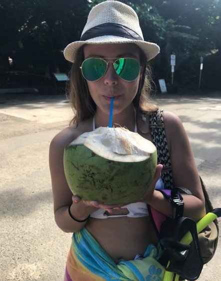 Rachel enjoying a coconut at Ke'e Beach in Ha'ena State Park
