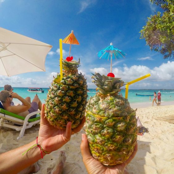 drinking pineapple pina coladas on playa blanca colombia